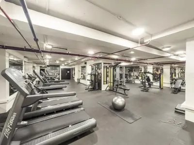 a gym with treadmills and machines in a room at Dubai 1BR City Views, Near Downtown Dining, Culture & Attractions in Dubai