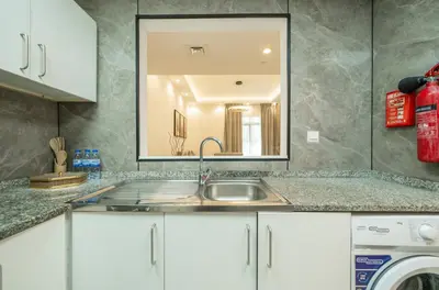 a kitchen with a sink and a mirror at Zapbed House-Stylish 2 BR in May Residence Block 1 -JVC in Dubai
