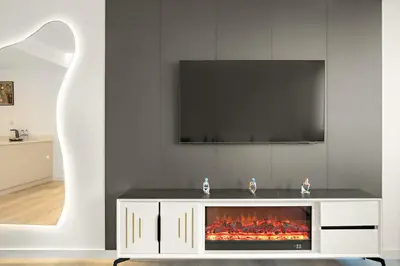 a living room with a tv and a fireplace at 2BR Dubai City Skyline View Near Marina Walk Dining Shops & JBR in Dubai