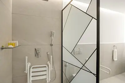a shower in a bathroom with a glass door at 2BR Dubai City Skyline View Near Marina Walk Dining Shops & JBR in Dubai