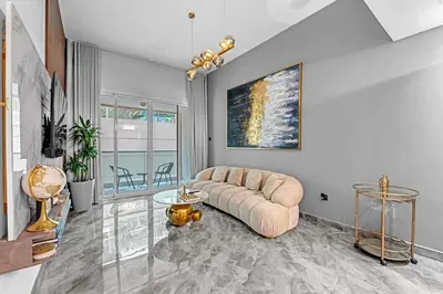 a living room with a couch and a table at Waves - Gold Opulence 1 BR in Marina in Dubai
