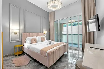a bedroom with a large bed and a television at Waves - Gold Opulence 1 BR in Marina in Dubai