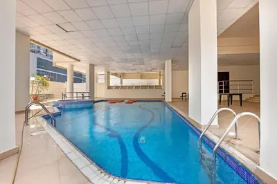 a large swimming pool in a building at Waves - Gold Opulence 1 BR in Marina in Dubai