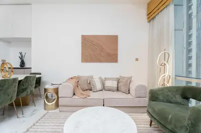 a living room with a couch and a table at 2BR Waterfront Apartment Nr Downtown in Dubai