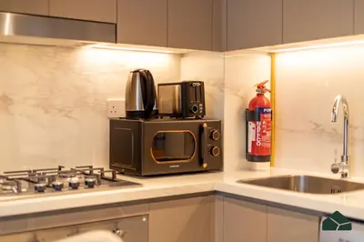a microwave oven sitting on top of a kitchen counter at Peaceful 2BR with Community Views by BMS in Dubai