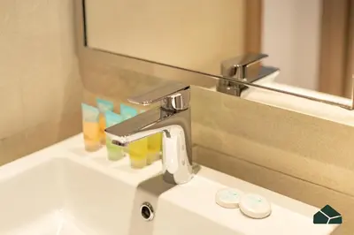 a bathroom sink with a faucet and a mirror at Peaceful 2BR with Community Views by BMS in Dubai