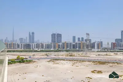 a beach in front of a city with tall buildings at Peaceful 2BR with Community Views by BMS in Dubai