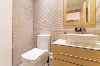 a bathroom with a white toilet and a sink at HAVN - 1 Spacious Bedroom in Belgravia 1, JVC in Dubai