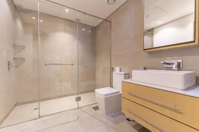 a bathroom with a toilet and a sink and a shower at HAVN - 1 Spacious Bedroom in Belgravia 1, JVC in Dubai