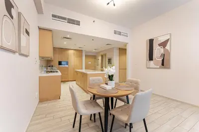 a kitchen and dining room with a table and chairs at HAVN - 1 Spacious Bedroom in Belgravia 1, JVC in Dubai