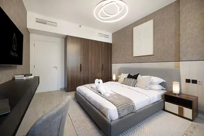 a bedroom with a large bed with a stuffed animal on it at Luxury apartment with Iconic Landmark View, pool, gym, free parking in Dubai