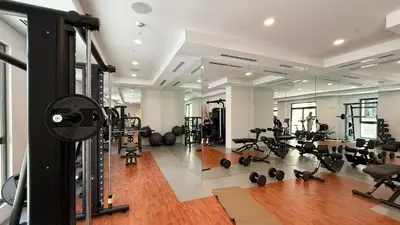 a gym with a lot of treadmills and weights at Luxury apartment with Iconic Landmark View, pool, gym, free parking in Dubai