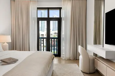 a bedroom with a bed and a tv and a window at DAYF-ROD Luxurious 2 Bed Apartment in Souk Al Bahar in Dubai