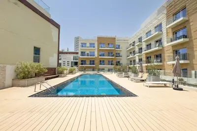 a swimming pool in the middle of a building at Urban Comfort 1Bedroom with Pool View in Oxford in Dubai
