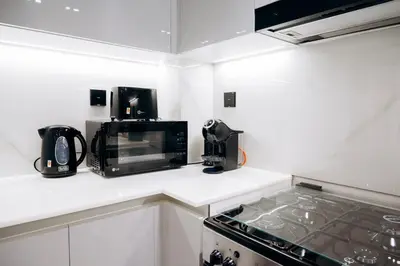 a kitchen with a counter top with a microwave at Amazing brand new 2BR - Business Bay-Binghatti in Dubai
