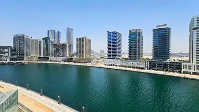 a river in a city with tall buildings at Luxurious Lake View 1BR - Business Bay - Pool - Gym in Dubai