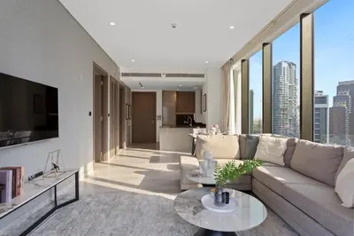 a living room with a couch and a table at Bright 1 Bedroom with Burj Khalifa view in Peninsula in Dubai
