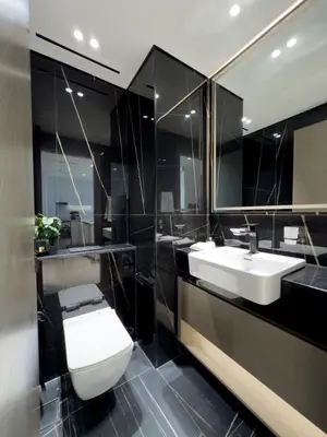 a bathroom with two sinks and a toilet and a mirror at Stunning 1BR in Binghatti Corner, JVC in Dubai