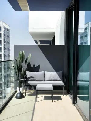 a couch sitting on the balcony of a building at Stunning 1BR in Binghatti Corner, JVC in Dubai