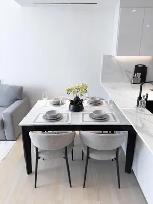 a dining room table with two chairs and a table at Stunning 1BR in Binghatti Corner, JVC in Dubai