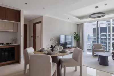 a kitchen and living room with a table and chairs at Luxury & Bright 1BR Apartment | Panoramic Sea View in Dubai