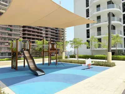 a playground with an umbrella and a play set at Luxury & Bright 1BR Apartment | Panoramic Sea View in Dubai