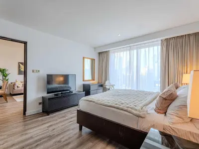 a bedroom with a large bed and a large window at Dubai Marina Luxury Lifestyle - Sun Sand & Views in Dubai