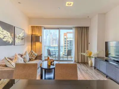 a living room with a couch and a large window at Dubai Marina Luxury Lifestyle - Sun Sand & Views in Dubai