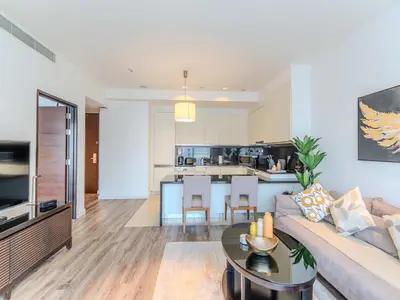 a living room with a couch and a table at Dubai Marina Luxury Lifestyle - Sun Sand & Views in Dubai