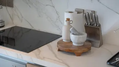 a counter with a vase and a bowl on a table at Most Luxurious 2BR Apt Beach Access & Palm View in Dubai