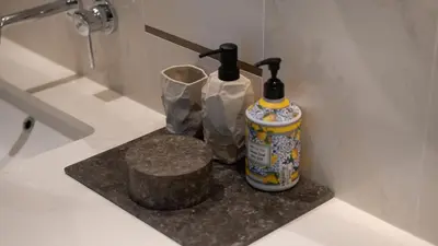 a bathroom with two bottles ofodorizers on a counter at Most Luxurious 2BR Apt Beach Access & Palm View in Dubai