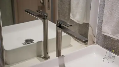 a sink with a faucet in a bathroom at Grove Luxurious Stu Best community Art & Design in Dubai
