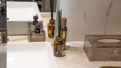 three bottles of essential oils sitting on a counter at GroveLuxurious 1BR BEST communityArt & Design in Dubai