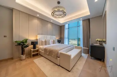 a bedroom with a large bed and a large window at Luxe Haven 1BR8min drive DubaiMall & BurjKhalifa in Dubai