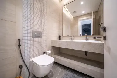 a bathroom with a toilet and a sink and a mirror at Luxury Comfort 1BRNear Dubai Mall & Burj Khalifa in Dubai