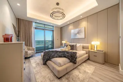 a bedroom with a large bed and a couch at GEM 2BR Prime Location 8 Min to Burj Khalifa in Dubai