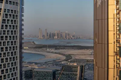 a view of a city with a beach between two buildings at Sky-High 2BR Escape Stylish Stay Near Dubai Mall in Dubai