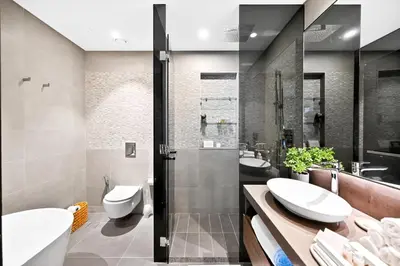 a bathroom with two sinks and two toilets at Luxury 1 Bedroom Apartment in Dubai Marina 5 Star in Dubai