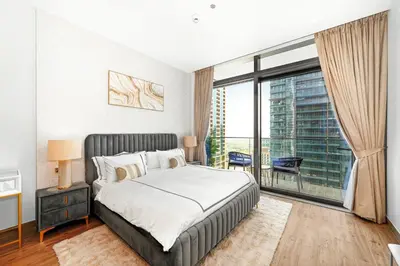a bedroom with a bed and a large window at Luxury 1 Bedroom Apartment in Dubai Marina 5 Star in Dubai