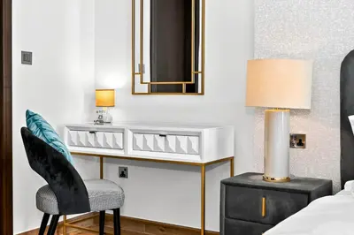 a bedroom with a vanity and a chair and a mirror at Luxury 1 Bedroom Apartment in Dubai Marina 5 Star in Dubai