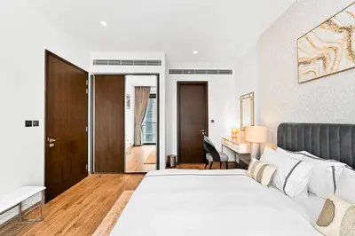 a bedroom with a white bed and a desk at Luxury 1 Bedroom Apartment in Dubai Marina 5 Star in Dubai