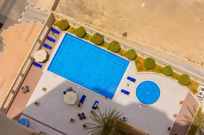an overhead view of a swimming pool on a beach at Royal Oceanic Elegant 2BR with Marina View in Dubai