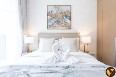 a bedroom with two white swans on a bed at Vogue Creek Beach Rosewater Waterfront Living close to Downtown, Burj Khalifa and Dubai mall, Two Bedroom Apartment with Balcony and Vibrant Community View, Private Manmade Beach, Access to all Amenities in Sabkhah
