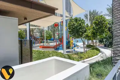 a view of a park with a playground at Vogue Creek Beach Rosewater Waterfront Living close to Downtown, Burj Khalifa and Dubai mall, Two Bedroom Apartment with Balcony and Vibrant Community View, Private Manmade Beach, Access to all Amenities in Sabkhah