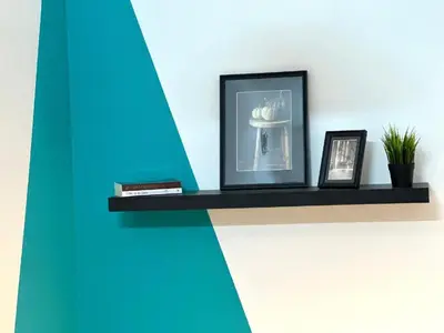 a shelf with a picture and two pictures on it at delightful Partition Room Barsha Heights Tecom in Dubai