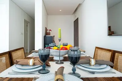 a dining room table with a bowl of fruit on it at DAYF-PAR Large 3 Bed with Full Skyline View in Dubai Hills in Dubai