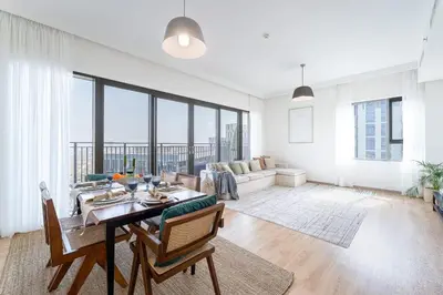 a living room with a table and a couch at DAYF-PAR Large 3 Bed with Full Skyline View in Dubai Hills in Dubai