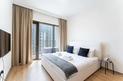 a bedroom with a large bed and a large window at DAYF-PAR Large 3 Bed with Full Skyline View in Dubai Hills in Dubai