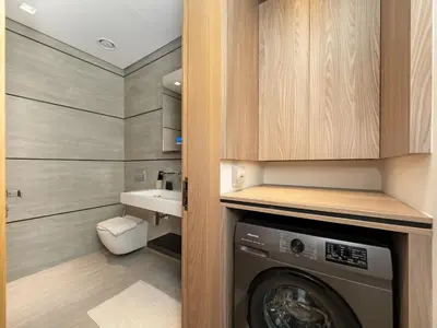 a laundry room with a washer and a sink at Brand New Luxury Duplex in 5 Star JVC Development in Dubai