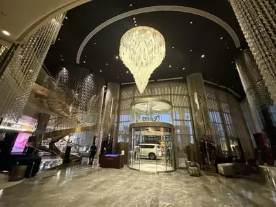 a large building with a chandelier in the middle at Luxurious paramount 2BR with Pool,Gym, Sauna & Bar 10 mins to Burj Khalifa in Dubai